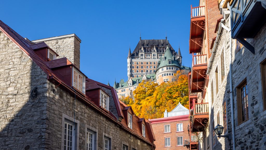 Exterior shot of residential apartments in Quebec City on a sunny day, with Chateau